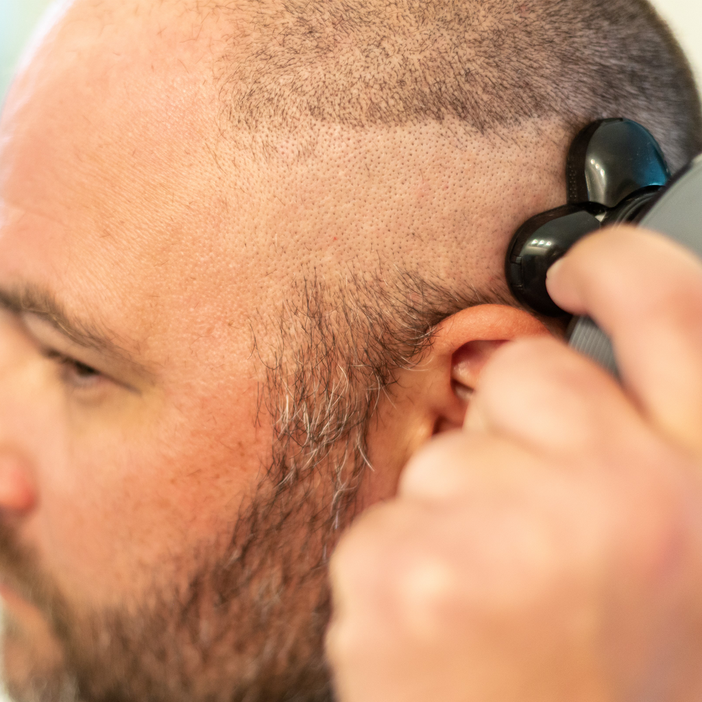 man shaving with electric razor without irritation
